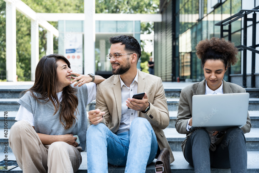 Group of business people walk outside in front of office buildings. Businessman and two businesswomen sharing experience ideas and tactic for successful strategy and marketing. Workers taking a break. Group of business people walk outside in front of office buildings. Businessman and two businesswomen sharing experience ideas and tactic for successful strategy and marketing. Workers taking a break.