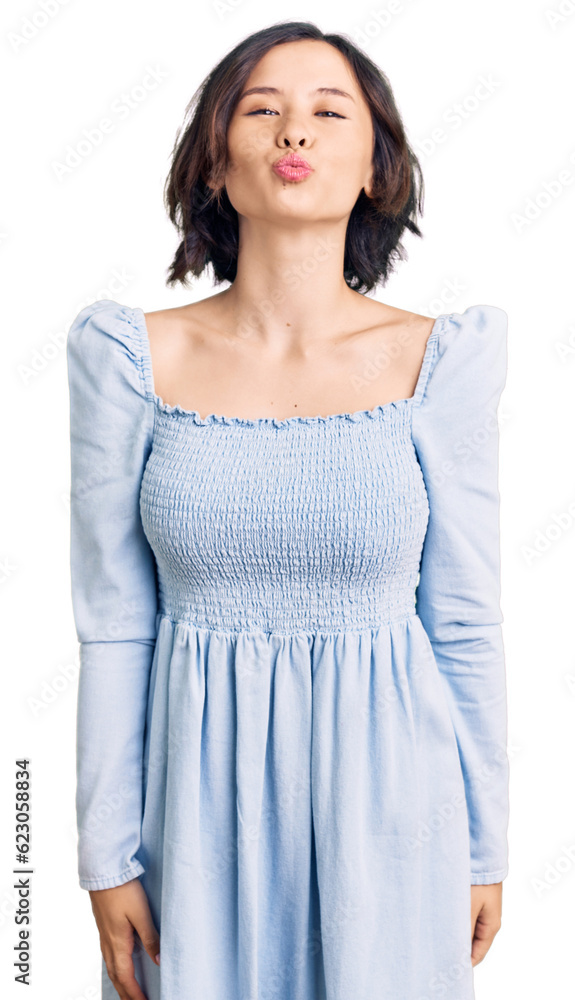 Young beautiful girl wearing casual clothes looking at the camera blowing a kiss on air being lovely and sexy. love expression. Young beautiful girl wearing casual clothes looking at the camera blowing a kiss on air being lovely and sexy. love expression.