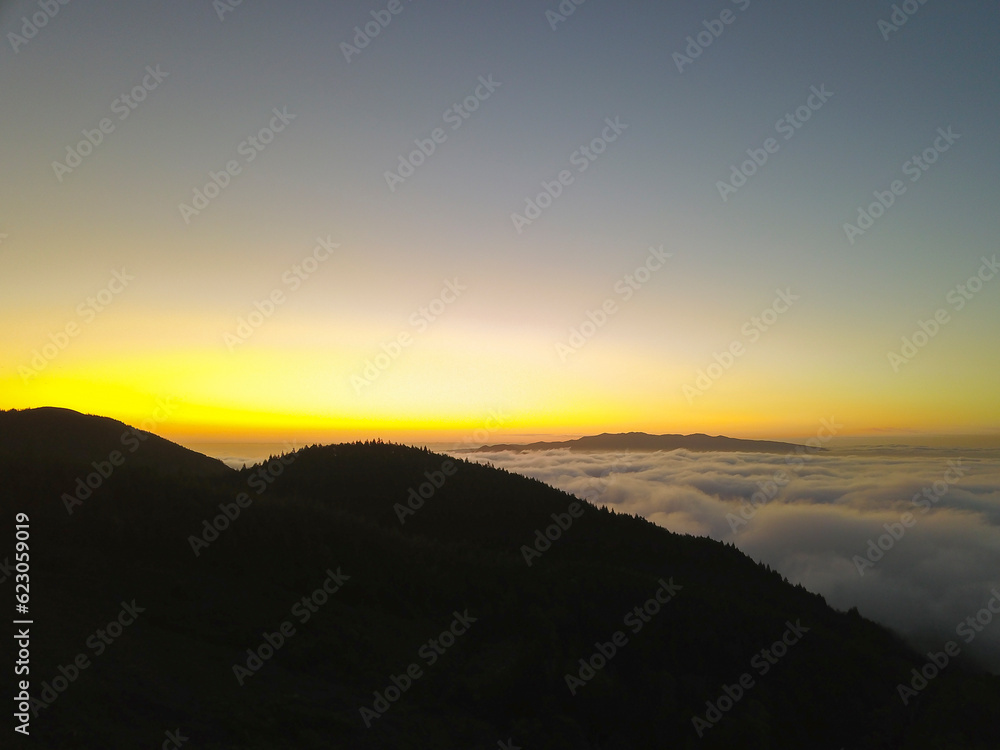 Sunset on the mountains above the clouds in the Fire Lake 