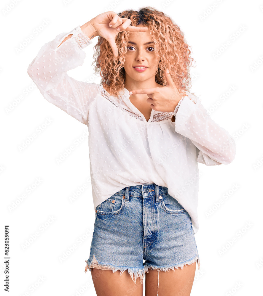 Young blonde woman with curly hair wearing elegant summer shirt smiling making frame with hands and fingers with happy face. creativity and photography concept. Young blonde woman with curly hair wearing elegant summer shirt smiling making frame with hands and fingers with happy face. creativity and photography concept.