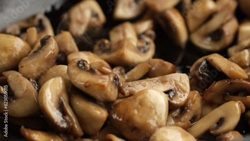 Stir and friy champignons mushrooms in pan photo