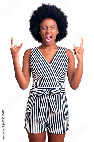 Young african american woman wearing casual clothes shouting with crazy expression doing rock symbol with hands up. music star. heavy concept.