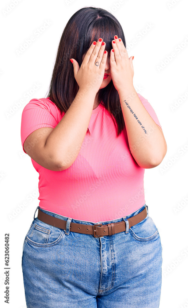 Young plus size woman wearing casual clothes with sad expression covering face with hands while crying. depression concept. Young plus size woman wearing casual clothes with sad expression covering face with hands while crying. depression concept.