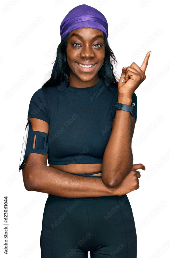 Young african american woman wearing sportswear smiling happy pointing with hand and finger to the side Young african american woman wearing sportswear smiling happy pointing with hand and finger to the side