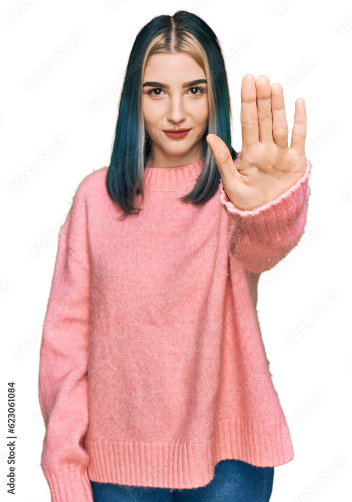 Young modern girl wearing pink wool winter sweater doing stop sing with palm of the hand. warning expression with negative and serious gesture on the face. Young modern girl wearing pink wool winter sweater doing stop sing with palm of the hand. warning expression with negative and serious gesture on the face.