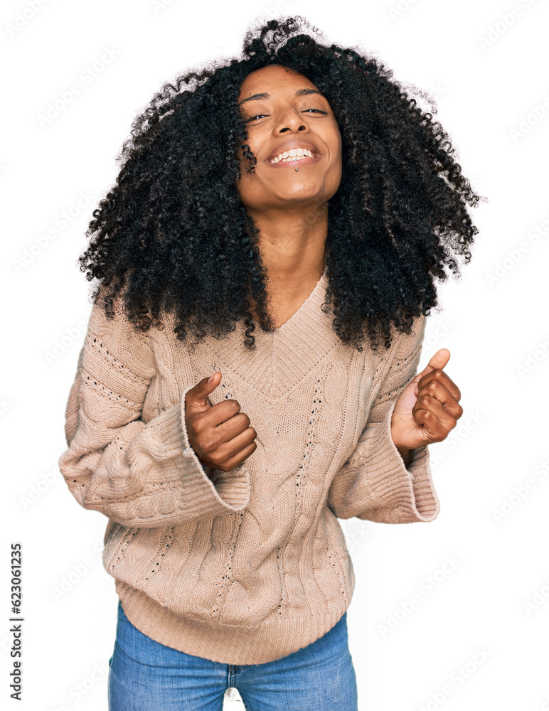 Young african american girl wearing casual clothes excited for success with arms raised and eyes closed celebrating victory smiling. winner concept. Young african american girl wearing casual clothes excited for success with arms raised and eyes closed celebrating victory smiling. winner concept.