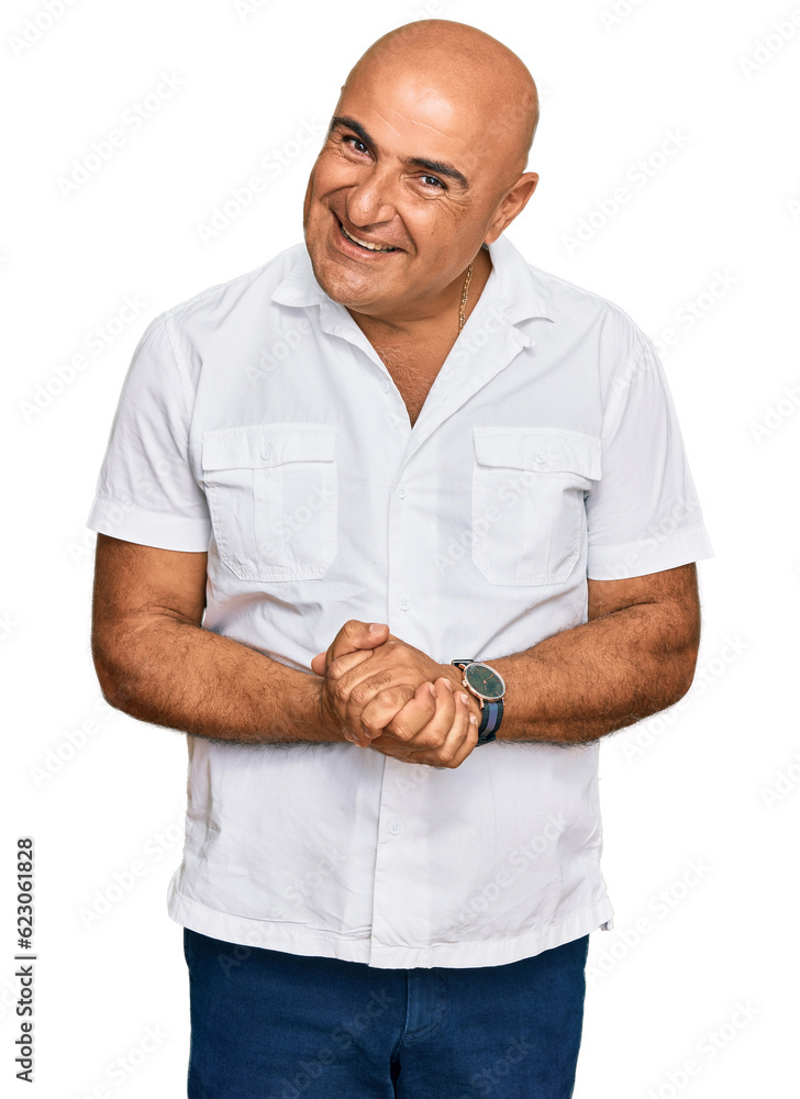Mature middle east man with mustache wearing casual white shirt with hands together and crossed fingers smiling relaxed and cheerful. success and optimistic