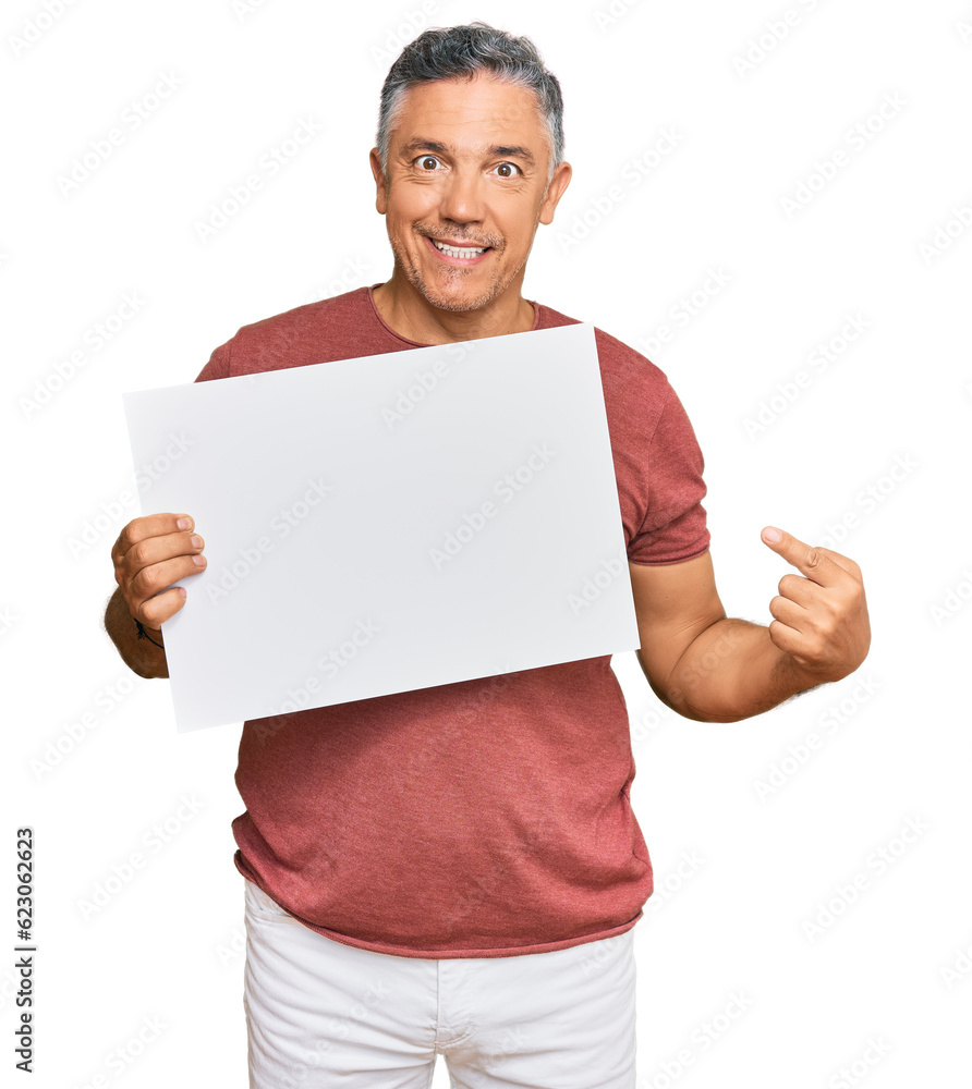 Handsome middle age man holding blank empty banner smiling happy pointing with hand and finger Handsome middle age man holding blank empty banner smiling happy pointing with hand and finger