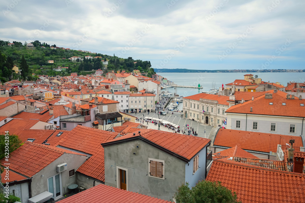 Panoramic top view of red tile roofs, Piran port and old town. Piran, Slavenia.