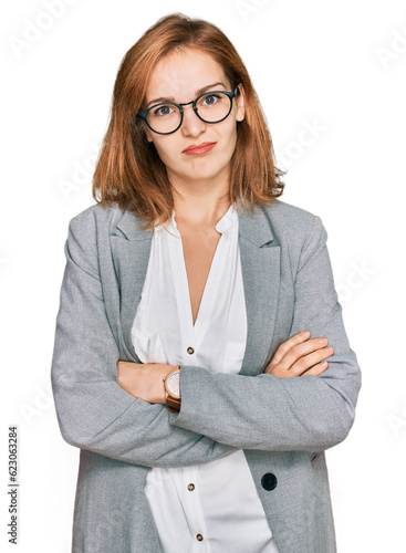 Young caucasian woman wearing business style and glasses looking sleepy and tired, exhausted for fatigue and hangover, lazy eyes in the morning. photo