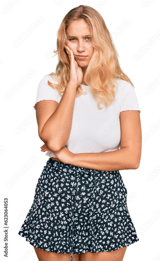 Young blonde girl wearing casual white tshirt thinking looking tired and bored with depression problems with crossed arms. Young blonde girl wearing casual white tshirt thinking looking tired and bored with depression problems with crossed arms.