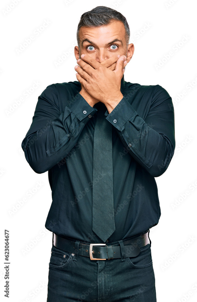 Middle age handsome man wearing business clothes shocked covering mouth with hands for mistake. secret concept. Middle age handsome man wearing business clothes shocked covering mouth with hands for mistake. secret concept.