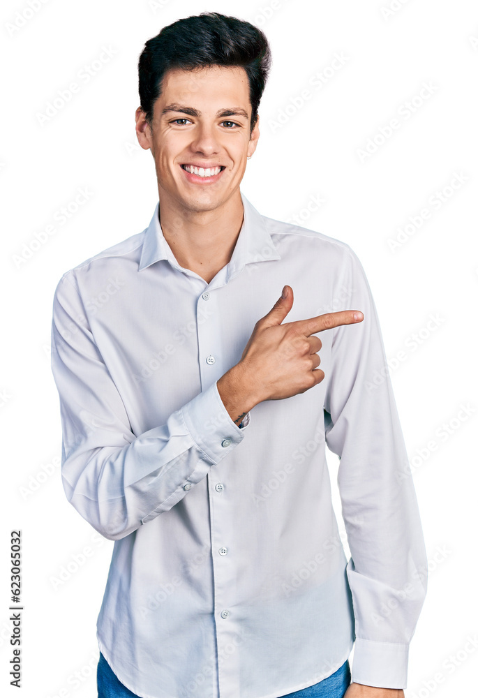 Young hispanic business man wearing business clothes cheerful with a smile of face pointing with hand and finger up to the side with happy and natural expression on face Young hispanic business man wearing business clothes cheerful with a smile of face pointing with hand and finger up to the side with happy and natural expression on face