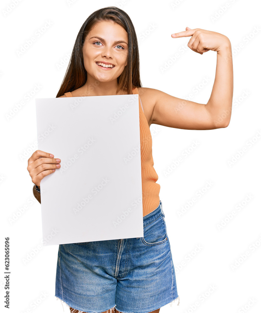 Young caucasian woman holding blank empty banner pointing finger to one self smiling happy and proud Young caucasian woman holding blank empty banner pointing finger to one self smiling happy and proud