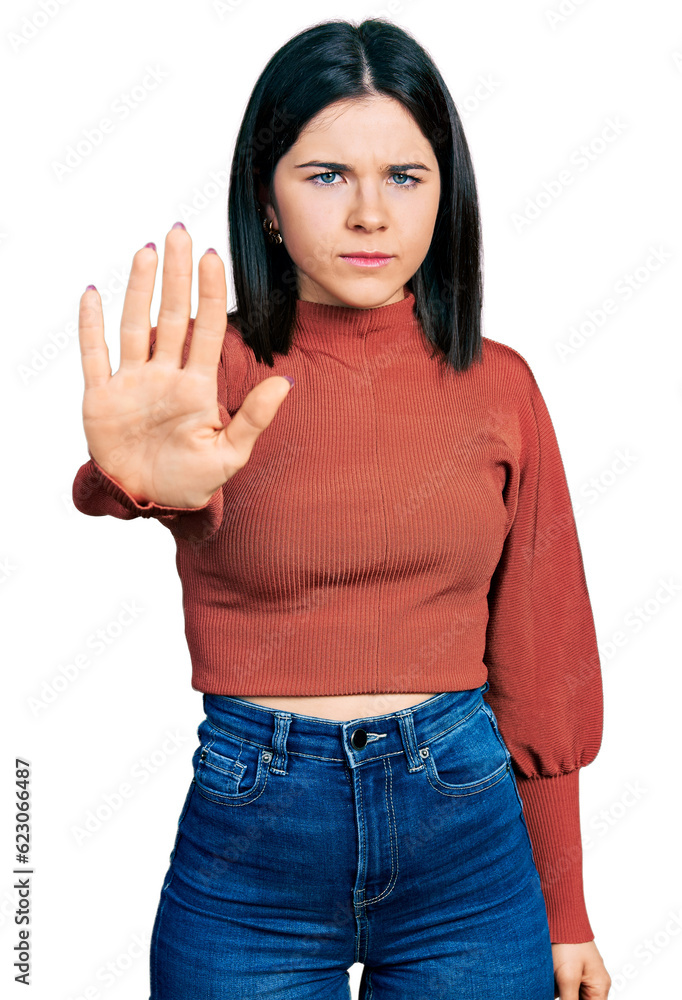 Young brunette woman with blue eyes wearing elegant sweater doing stop sing with palm of the hand. warning expression with negative and serious gesture on the face. Young brunette woman with blue eyes wearing elegant sweater doing stop sing with palm of the hand. warning expression with negative and serious gesture on the face.