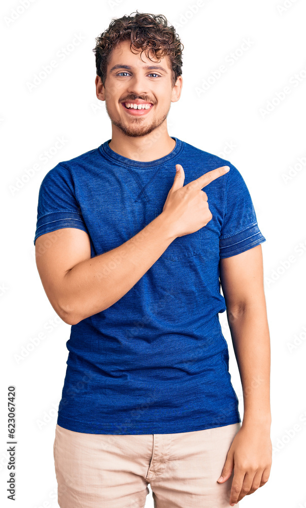 Young handsome man with curly hair wearing casual clothes cheerful with a smile of face pointing with hand and finger up to the side with happy and natural expression on face Young handsome man with curly hair wearing casual clothes cheerful with a smile of face pointing with hand and finger up to the side with happy and natural expression on face