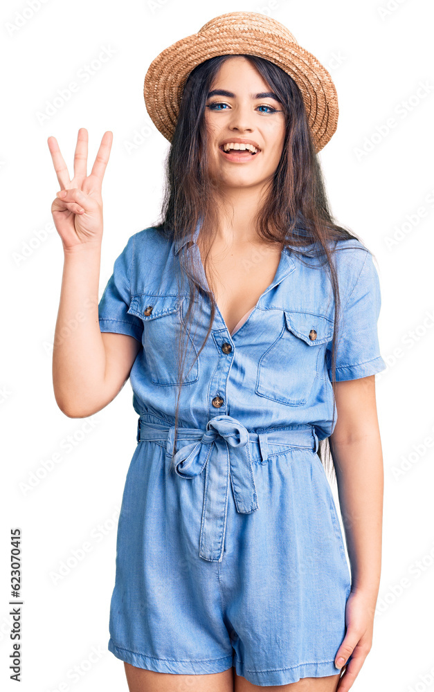 Brunette teenager girl wearing summer hat showing and pointing up with fingers number three while smiling confident and happy. Brunette teenager girl wearing summer hat showing and pointing up with fingers number three while smiling confident and happy.