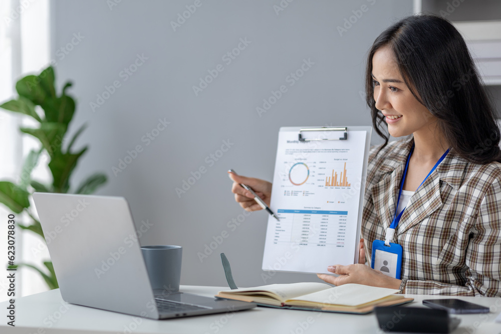 Young beautiful asian woman working in corporate office, businesswoman working in office attentively to grow and modernize start-up business, she is analyzing company's market and financial data. Young beautiful asian woman working in corporate office, businesswoman working in office attentively to grow and modernize start-up business, she is analyzing company's market and financial data.