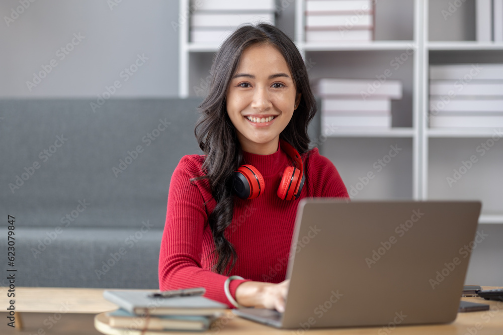 Beautiful asian woman sitting in living room, she is student doing report and homework for class, homeschooling, online learning. University student concept. Beautiful asian woman sitting in living room, she is student doing report and homework for class, homeschooling, online learning. University student concept.