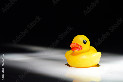 yellow rubber duck on black background
