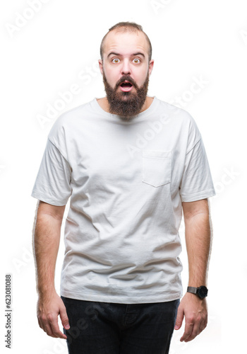 Young caucasian hipster man wearing casual t-shirt over isolated background afraid and shocked with surprise expression, fear and excited face.