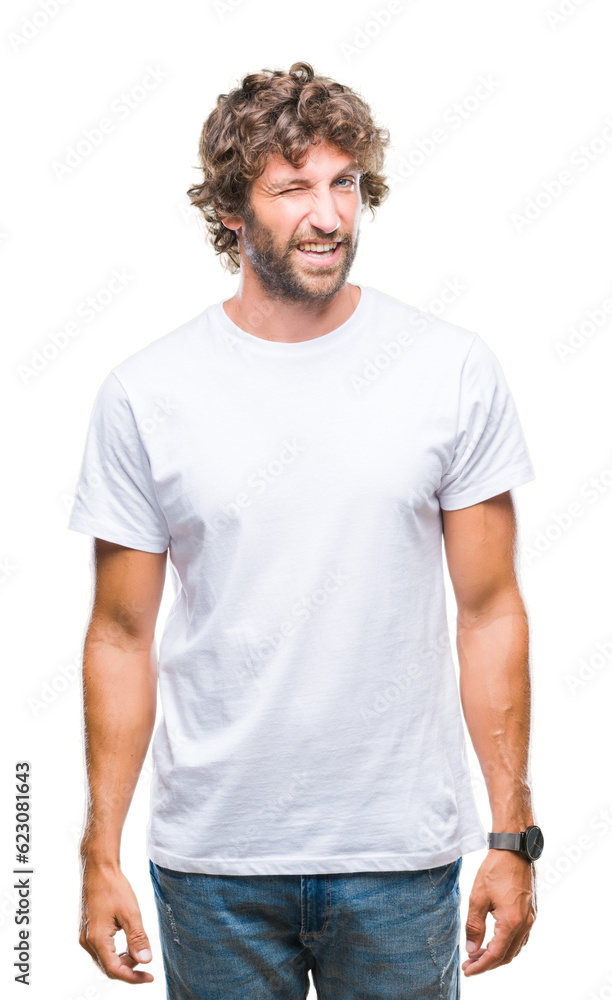 Handsome hispanic model man over isolated background winking looking at the camera with sexy expression, cheerful and happy face.
