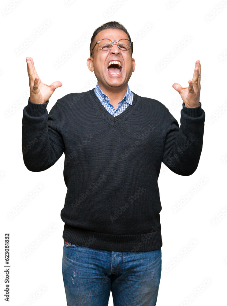 Middle age bussines arab man wearing glasses over isolated background crazy and mad shouting and yelling with aggressive expression and arms raised. Frustration concept. Middle age bussines arab man wearing glasses over isolated background crazy and mad shouting and yelling with aggressive expression and arms raised. Frustration concept.