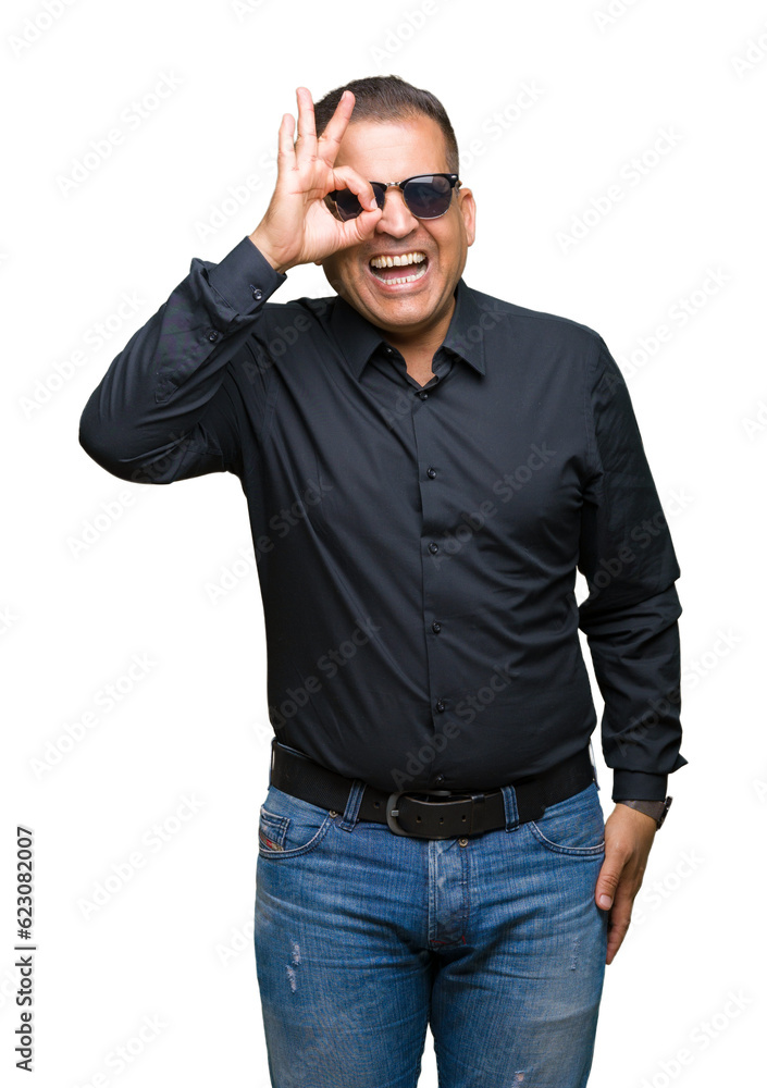Middle age arab man wearing sunglasses over isolated background doing ok gesture with hand smiling, eye looking through fingers with happy face. Middle age arab man wearing sunglasses over isolated background doing ok gesture with hand smiling, eye looking through fingers with happy face.