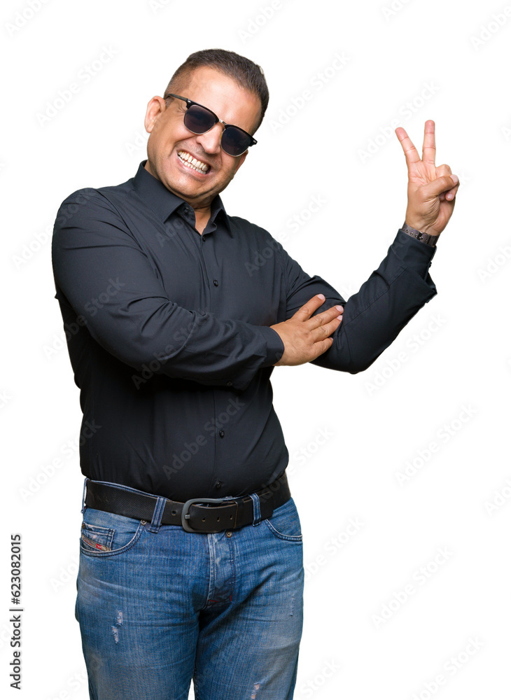 Middle age arab man wearing sunglasses over isolated background smiling with happy face winking at the camera doing victory sign. Number two. Middle age arab man wearing sunglasses over isolated background smiling with happy face winking at the camera doing victory sign. Number two.