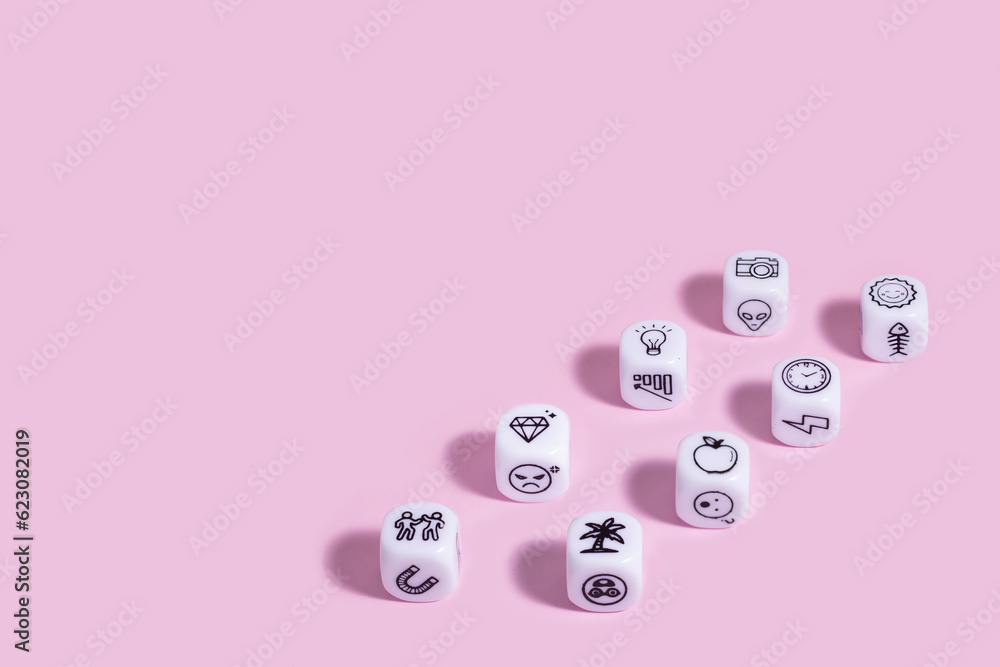 Story dice cubes on pastel pink backround. Story dice cubes on pastel pink backround.