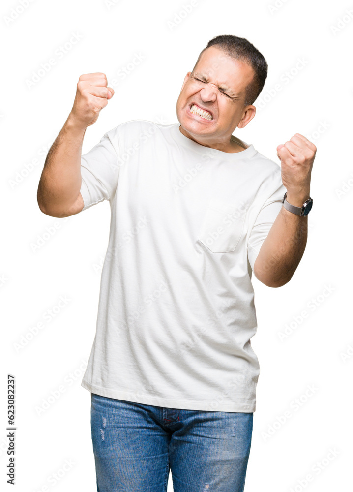 Middle age arab man wearig white t-shirt over isolated background very happy and excited doing winner gesture with arms raised, smiling and screaming for success. Celebration concept. Middle age arab man wearig white t-shirt over isolated background very happy and excited doing winner gesture with arms raised, smiling and screaming for success. Celebration concept.