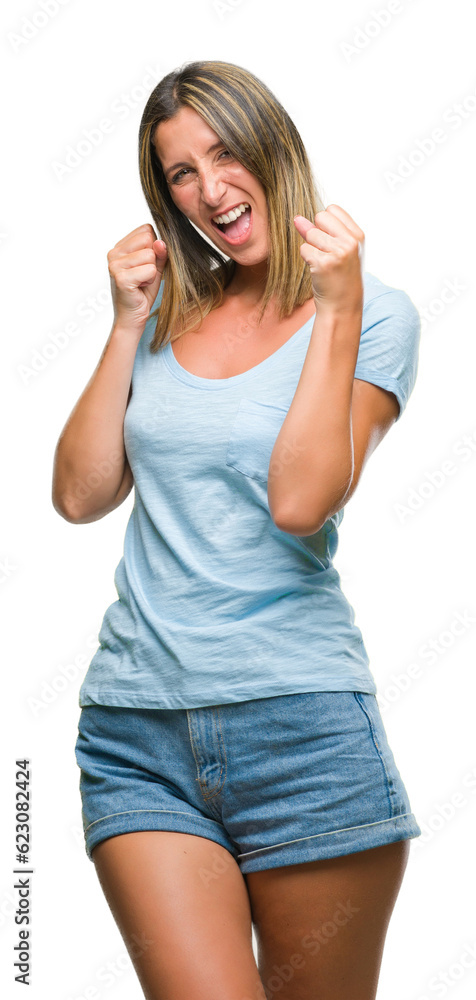 Young beautiful woman over isolated background very happy and excited doing winner gesture with arms raised, smiling and screaming for success. Celebration concept.