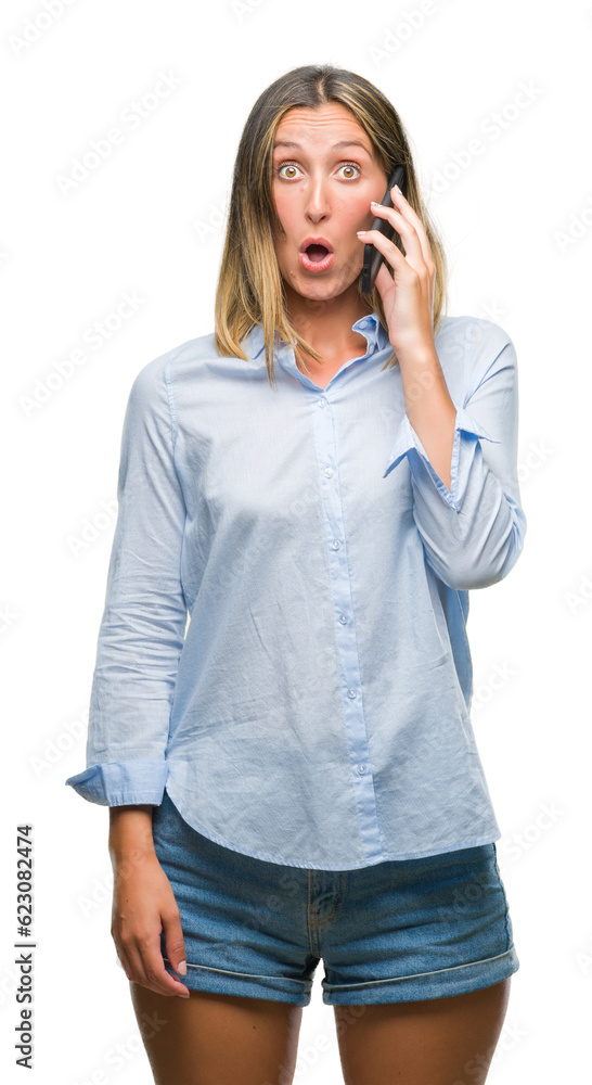Young beautiful woman talking on smartphone over isolated background scared in shock with a surprise face, afraid and excited with fear expression Young beautiful woman talking on smartphone over isolated background scared in shock with a surprise face, afraid and excited with fear expression