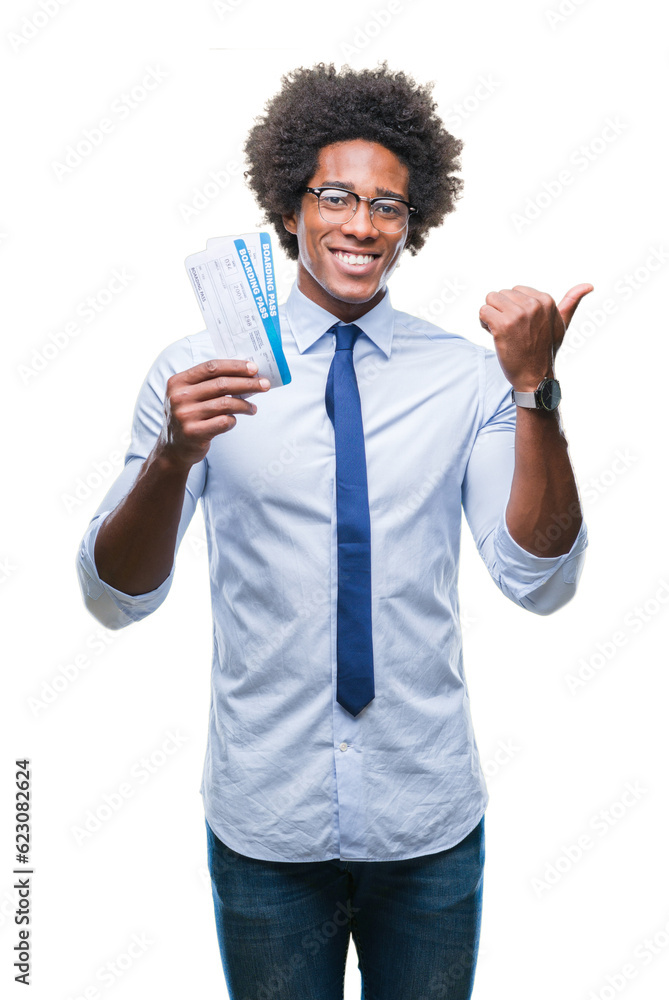 Afro american man holding boarding pass over isolated background pointing and showing with thumb up to the side with happy face smiling Afro american man holding boarding pass over isolated background pointing and showing with thumb up to the side with happy face smiling