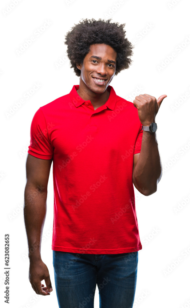 Afro american man over isolated background smiling with happy face looking and pointing to the side with thumb up. Afro american man over isolated background smiling with happy face looking and pointing to the side with thumb up.