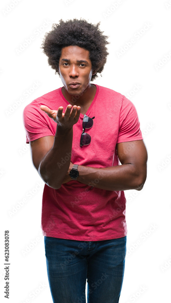 Afro american man over isolated background looking at the camera blowing a kiss with hand on air being lovely and sexy. Love expression. Afro american man over isolated background looking at the camera blowing a kiss with hand on air being lovely and sexy. Love expression.