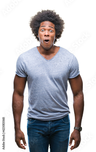 Afro american man over isolated background afraid and shocked with surprise expression, fear and excited face.