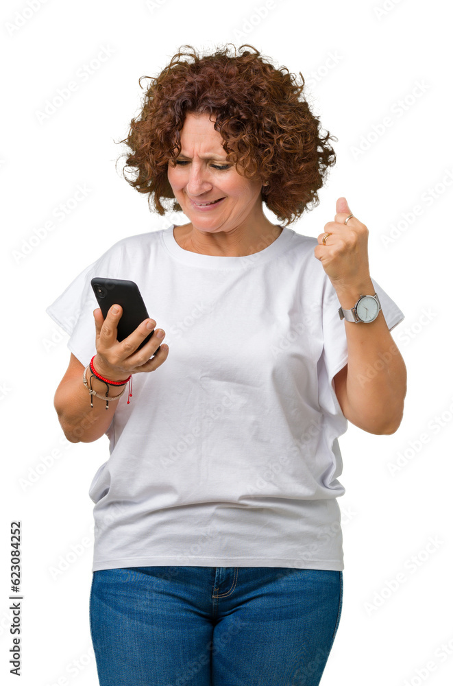 Middle ager senior woman using and texting with smartphone over isolated background screaming proud and celebrating victory and success very excited, cheering emotion Middle ager senior woman using and texting with smartphone over isolated background screaming proud and celebrating victory and success very excited, cheering emotion