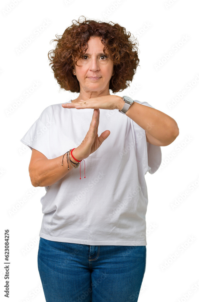 Beautiful middle ager senior woman wearing white t-shirt over isolated background Doing time out gesture with hands, frustrated and serious face Beautiful middle ager senior woman wearing white t-shirt over isolated background Doing time out gesture with hands, frustrated and serious face