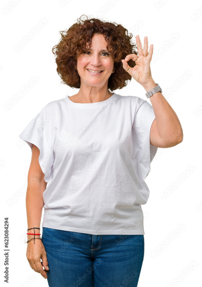 Beautiful middle ager senior woman wearing white t-shirt over isolated background smiling positive doing ok sign with hand and fingers. Successful expression. Beautiful middle ager senior woman wearing white t-shirt over isolated background smiling positive doing ok sign with hand and fingers. Successful expression.