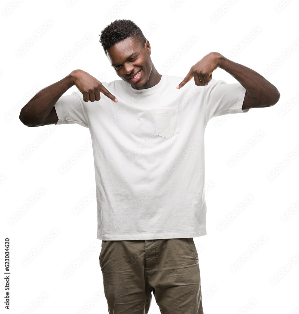 Young african american man wearing white t-shirt looking confident with smile on face, pointing oneself with fingers proud and happy. Young african american man wearing white t-shirt looking confident with smile on face, pointing oneself with fingers proud and happy.