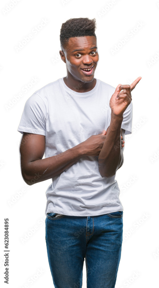 Young african american man over isolated background with a big smile on face, pointing with hand and finger to the side looking at the camera. Young african american man over isolated background with a big smile on face, pointing with hand and finger to the side looking at the camera.