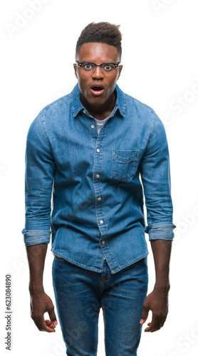 Young african american man over isolated background afraid and shocked with surprise expression, fear and excited face.