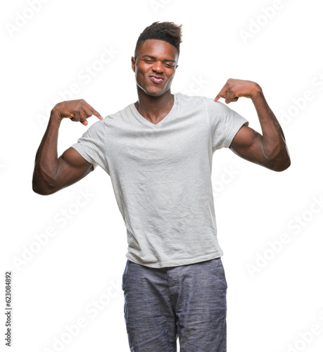 Young african american man over isolated background looking confident with smile on face, pointing oneself with fingers proud and happy.