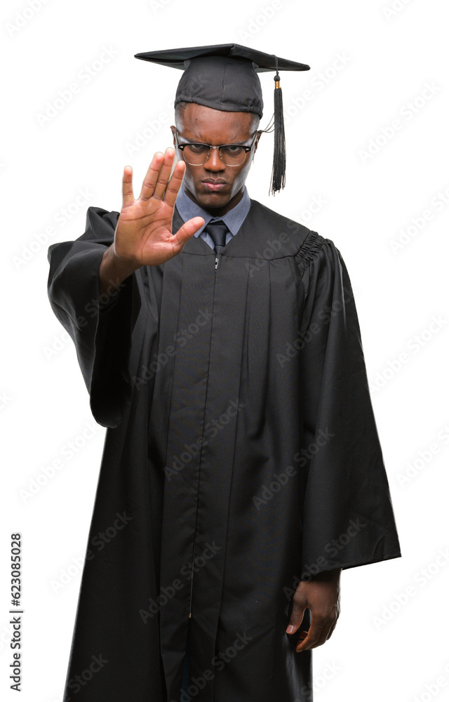 Young graduated african american man over isolated background doing stop sing with palm of the hand. Warning expression with negative and serious gesture on the face. Young graduated african american man over isolated background doing stop sing with palm of the hand. Warning expression with negative and serious gesture on the face.