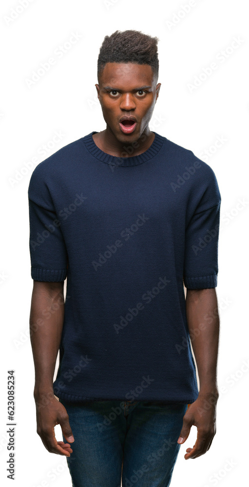 Young african american man over isolated background afraid and shocked with surprise expression, fear and excited face. Young african american man over isolated background afraid and shocked with surprise expression, fear and excited face.