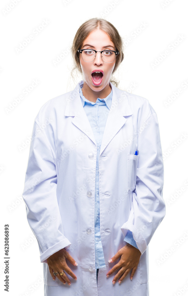 Beautiful young blonde doctor woman wearing white coat over isolated background afraid and shocked with surprise expression, fear and excited face. Beautiful young blonde doctor woman wearing white coat over isolated background afraid and shocked with surprise expression, fear and excited face.