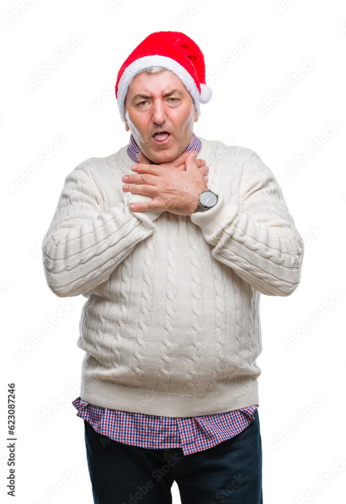 Handsome senior man wearing christmas hat over isolated background shouting and suffocate because painful strangle. Health problem. Asphyxiate and suicide concept.