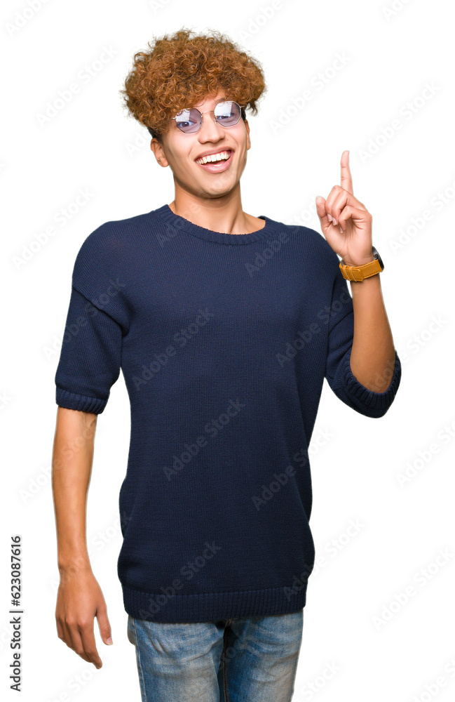 Young handsome man with afro wearing glasses pointing finger up with successful idea. Exited and happy. Number one. Young handsome man with afro wearing glasses pointing finger up with successful idea. Exited and happy. Number one.