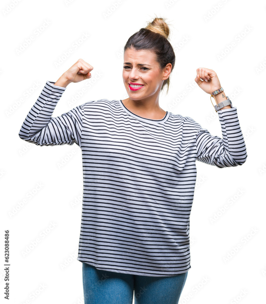 Young beautiful woman casual stripes sweater over isolated background showing arms muscles smiling proud. Fitness concept. Young beautiful woman casual stripes sweater over isolated background showing arms muscles smiling proud. Fitness concept.
